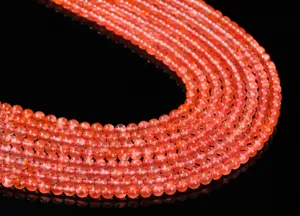 Gros plan de perles rondes en agate rouge du sud naturelle rouge cerise translucide