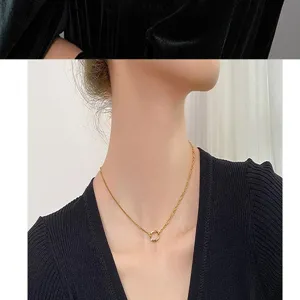Close-up of elegant gold interlocking double ring necklace worn on a model's neck
