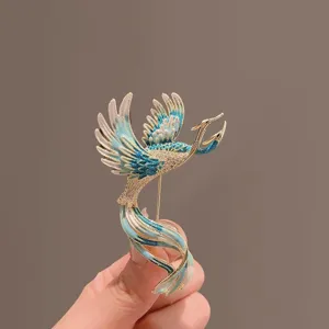 Elegante spilla a fenice con smalto blu squisito e strass scintillanti per le donne.