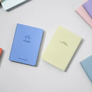 Pocket notebook detail shot showing cute cat cover illustration and compact portable design.