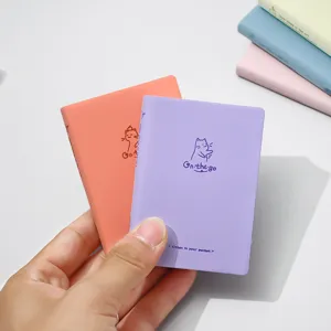 Mini portable pocket notebook with cute cat cover, perfect for travel journaling collection.