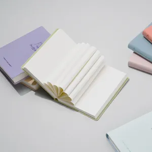 Portable pocket notebook with unique folded pages and pastel hardcover, ideal for travel diary.
