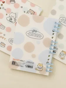 A6 cute cat pattern loose-leaf notebook with blue spiral binding and soft pastel dots.