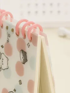 Cute mini ring notebook detail shot with frosted translucent cover and pink binder rings.