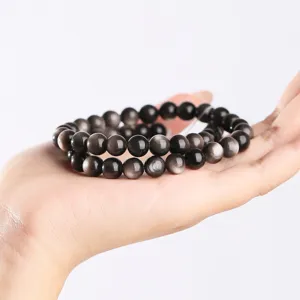 Silver sheened obsidian beaded bracelet displayed on hand