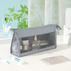 Close-up detail view of the gray twill mesh travel cosmetic bag with zipper and mesh.