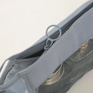 Grey mesh travel cosmetic bag detail, showing smooth zipper pull and durable fabric texture.