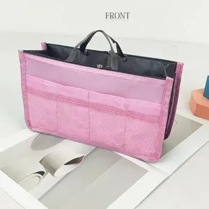 Pink multi-pocket handbag organizer detail, featuring mesh compartments and dual zipper.