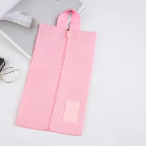 Pink travel shoe bag detail, portable zipper dustproof organizer for footwear storage.