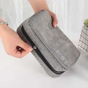Portable grey travel toiletry bag with smooth zipper and cosmetic icons for daily use.