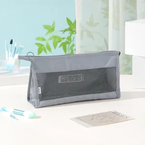 Grey travel toiletry bag detail, portable mesh makeup pouch with zipper and side handle.