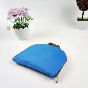 Detail view of the blue folding backpack showing compact oxford cloth design and durable zipper.