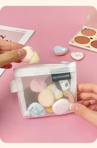 Portable white mesh cosmetic bag with colorful makeup puffs, ideal for travel and daily use.