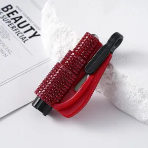 Detail view of emergency red rhinestone-studded car window breaker and safety hammer tool