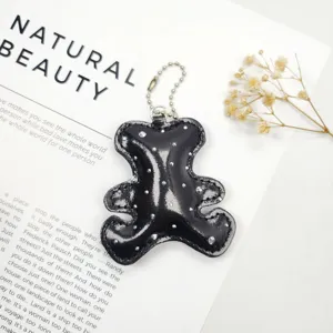 Detailed shot of a bear shaped leather keychain with shiny rhinestone accents