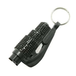 Close-up of portable rhinestone-encrusted car escape window breaker keychain tool