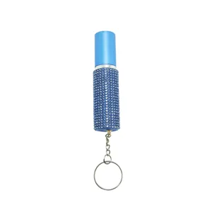 Detailed view of the 5ml blue rhinestone-encrusted portable perfume atomizer keychain.