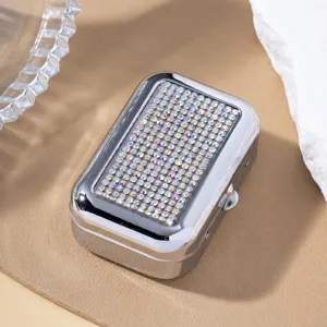 Macro view of the sparkling rhinestone embellishments on the silver metal box lid.