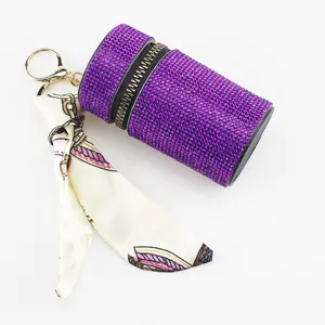 Detailed view of purple rhinestone lipstick case keychain with elegant silk scarf.