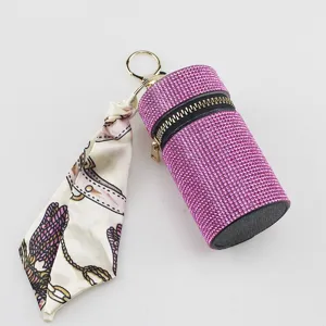 Exquisite detail of pink rhinestone lipstick pouch keychain with floral silk scarf accessory
