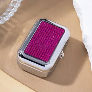 Detailed macro view of magenta rhinestones on a silver metal portable pill box.