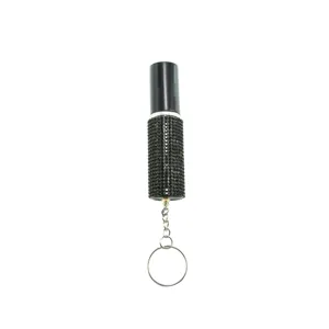 Macro detail of portable 5ml perfume atomizer with black rhinestones and keychain