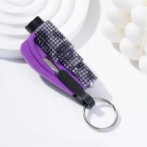 Detailed close-up of rhinestone-studded purple emergency car window breaker tool with keychain