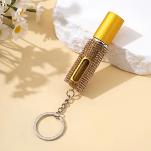 Détail d'un atomiseur de parfum de 5 ml orné de strass dorés en porte-clés élégant