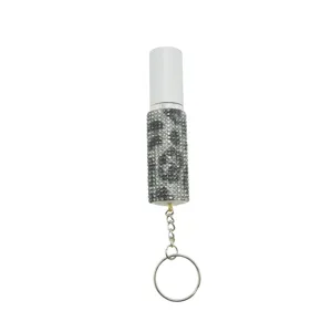 Close-up of sparkling rhinestone encrusted 5ml refillable perfume spray bottle with keychain