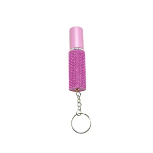 Detailed view of a pink rhinestone-encrusted 5ml perfume atomizer with silver keychain ring
