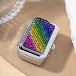 Detailed view of a rectangular silver metal case encrusted with rainbow gradient rhinestones