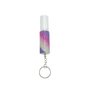 Close-up of a 5ml portable perfume atomizer with gradient rhinestone inlay and keychain.