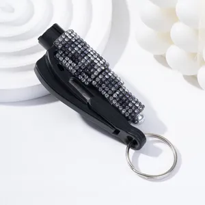 Close-up of a black car safety hammer keychain decorated with sparkling rhinestones.