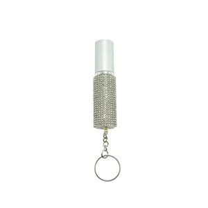 Close-up of a 5ml portable perfume atomizer with sparkling rhinestone body and keychain.