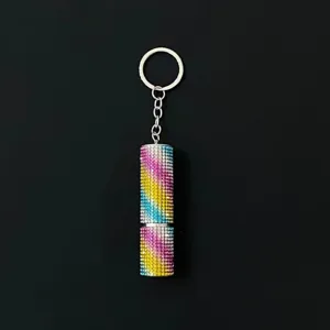 Macro view of rainbow rhinestone-encrusted 5ml perfume atomizer keychain for women
