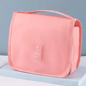 Trousse de toilette de voyage rose avec poignée et crochet pour un rangement étanche et facile.