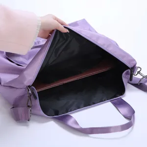 Travel bag interior detail showcasing spacious compartment and durable purple fabric.