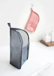 Detail shot of the grey mesh toiletry bag, standing upright with breathable design.
