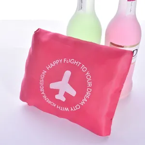 Pink foldable travel luggage bag with cute airplane print, large capacity portable storage bag.