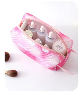 Detail of portable waterproof pink quilted makeup bag showing spacious interior storage.