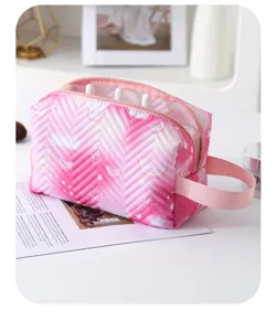 Detailed view of pink quilted makeup bag with chevron pattern and butterfly print