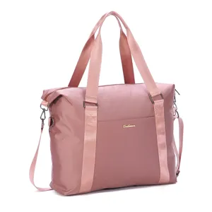 Pink waterproof nylon travel duffel bag with durable handles and shoulder strap for women.
