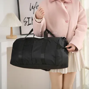 Detailed view of the black travel duffel bag showcasing durable handles and large capacity.