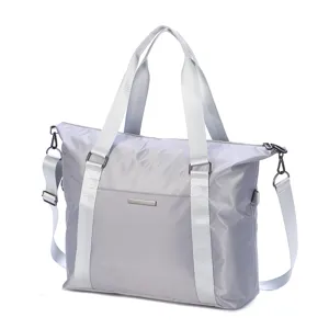 Detailed view of the large capacity grey travel luggage bag, durable waterproof fabric and straps.