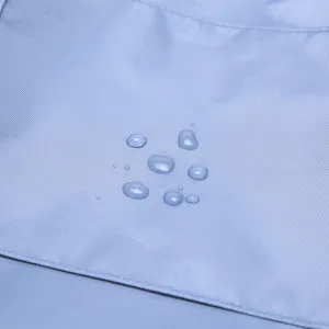 Close-up of durable light blue waterproof fabric detail showing water repellent performance.