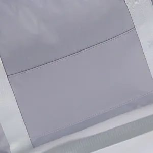Gray travel bag detail close-up showing durable waterproof fabric and reinforced webbing straps.