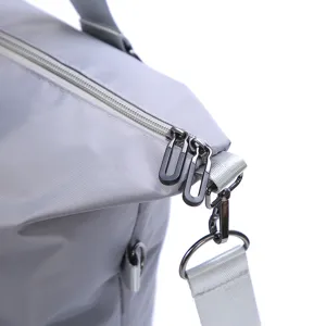 Close-up detail shot of durable travel bag zipper and metal hardware connector.