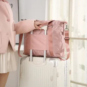 Large capacity pink travel duffel bag with luggage sleeve and shoulder strap for travel.