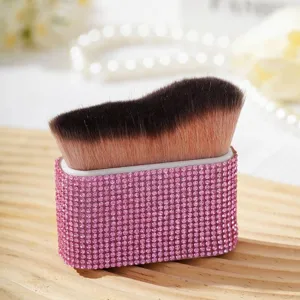 Vue macro détaillée du gros pinceau poudre doux avec un manche luxueux en strass roses