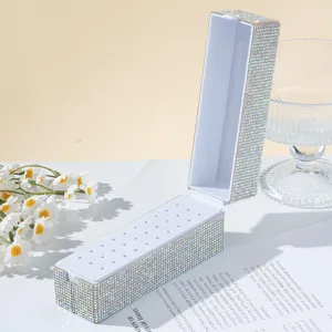 High-detail macro shot of 30-hole rhinestone nail drill bit box with crystals